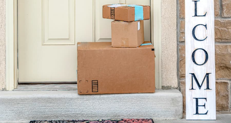 Deliveries on the front porch of a house with a welcome sign in Bowling Green